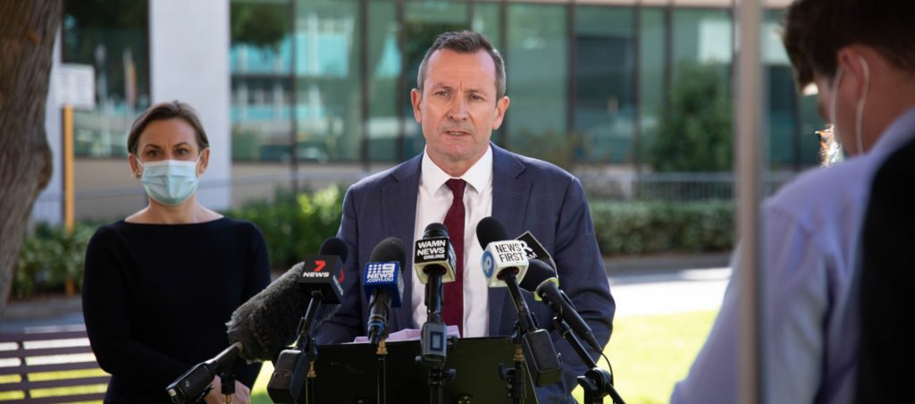 WA Premier Mark McGowan in front of microphones at a press conference