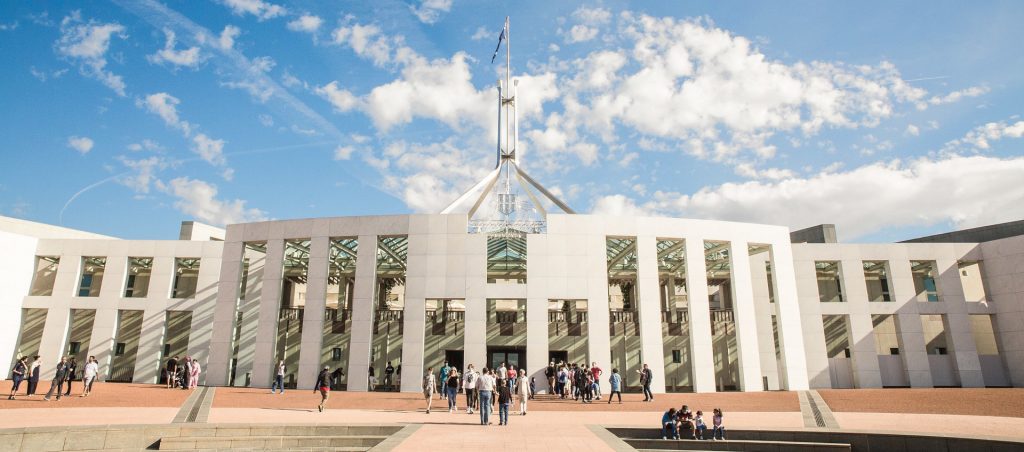 Crowd of people walking into Parliament House in Canberra, Australia